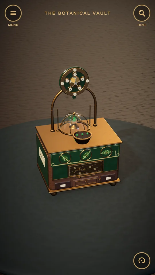 A green and gold puzzle box with a domed plant chamber on top.